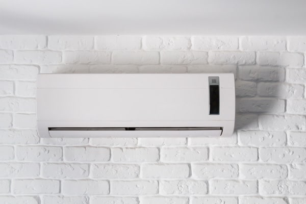 wall-mounted air conditioner on bricks.