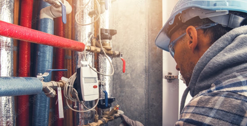 HVAC technician checking the status of a heating system.