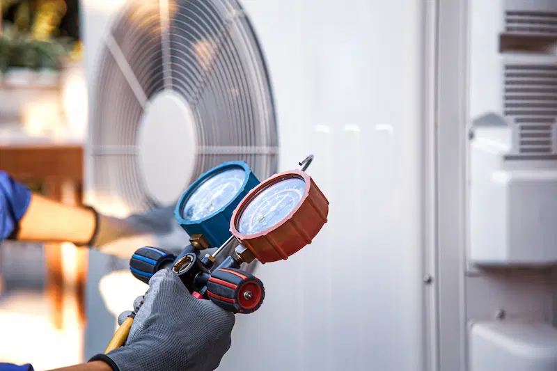 Technician checking a heat pump system during maintenance